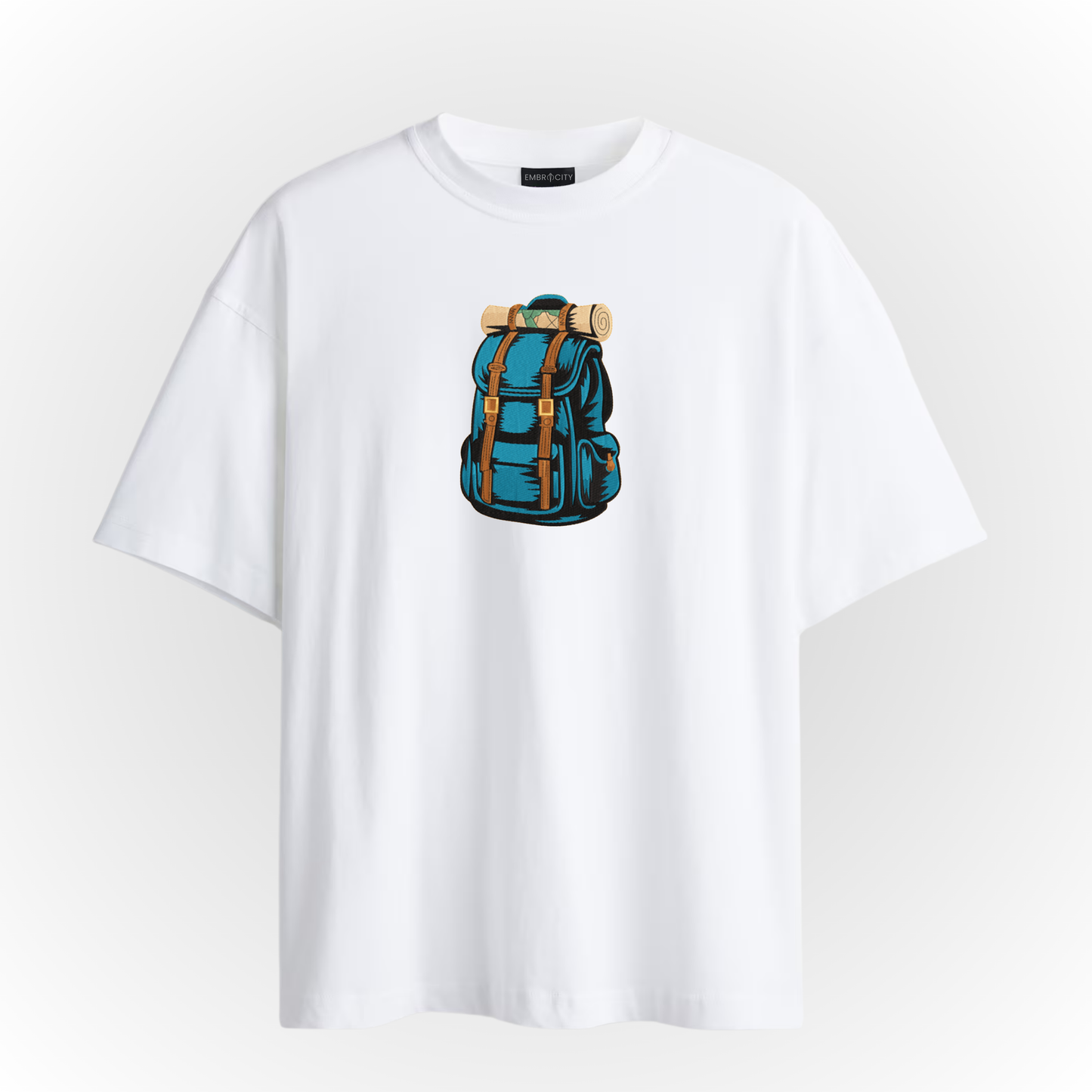 White t-shirt with a blue backpack embroidery on a light gray background