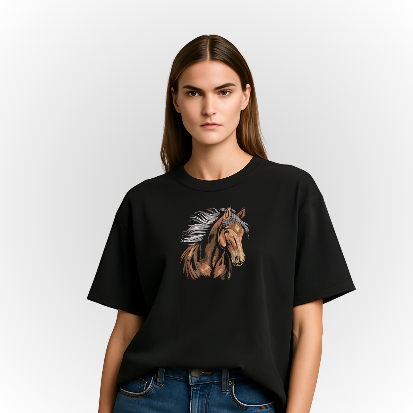 Person wearing a black t-shirt with a majestic horse embroidery on a plain background
